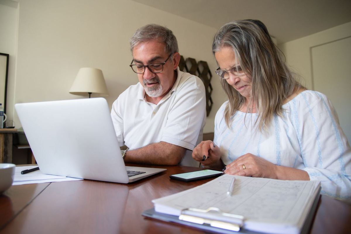 An older couple going through documents together at home